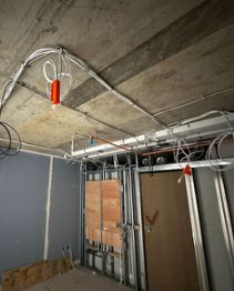 First-fix containment and cabling across a concrete soffit
